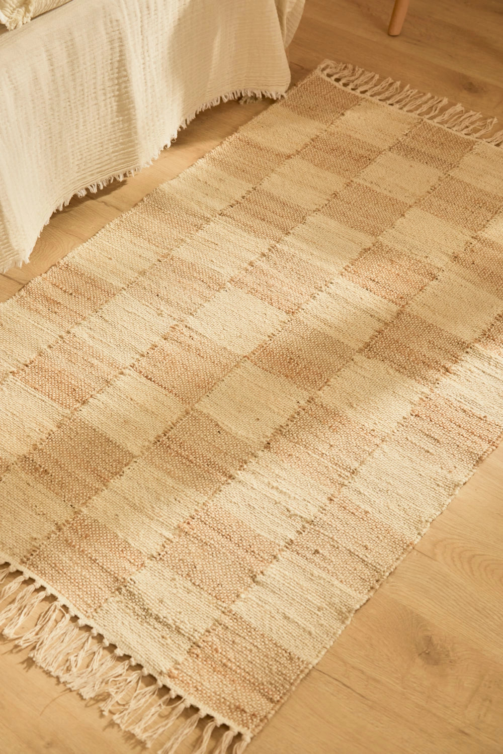 Alfombra de yute natural teñido, con trenzado artesanal y diseño a cuadros